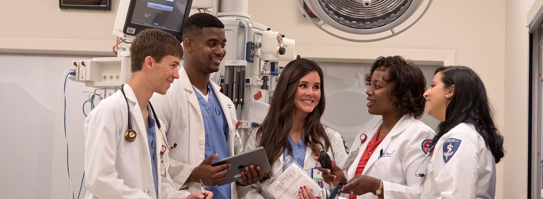 Medical students chatting with School of Medicine faculty member